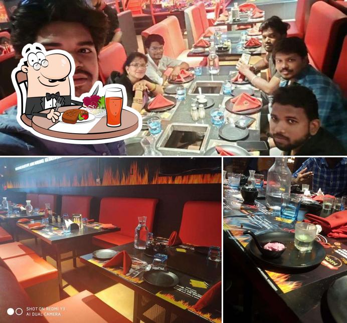 The photo of SMOKE HUB BARBEQUE - VELACHERY’s dining table and interior