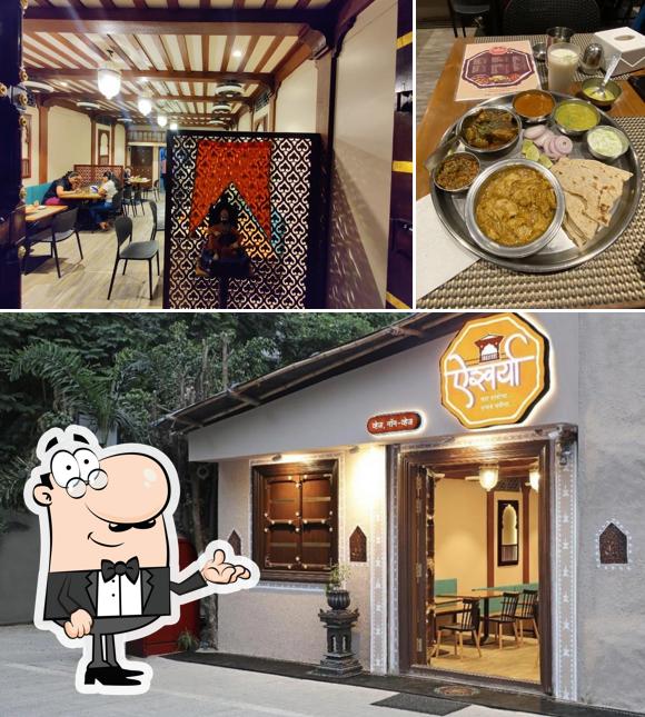 Take a seat at one of the tables at Hotel Aishwarya Veg & Non-Veg