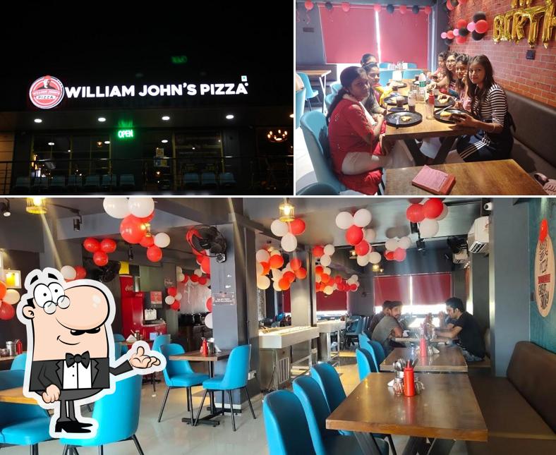 The picture of interior and dining table at William John's Pizza - Vapi