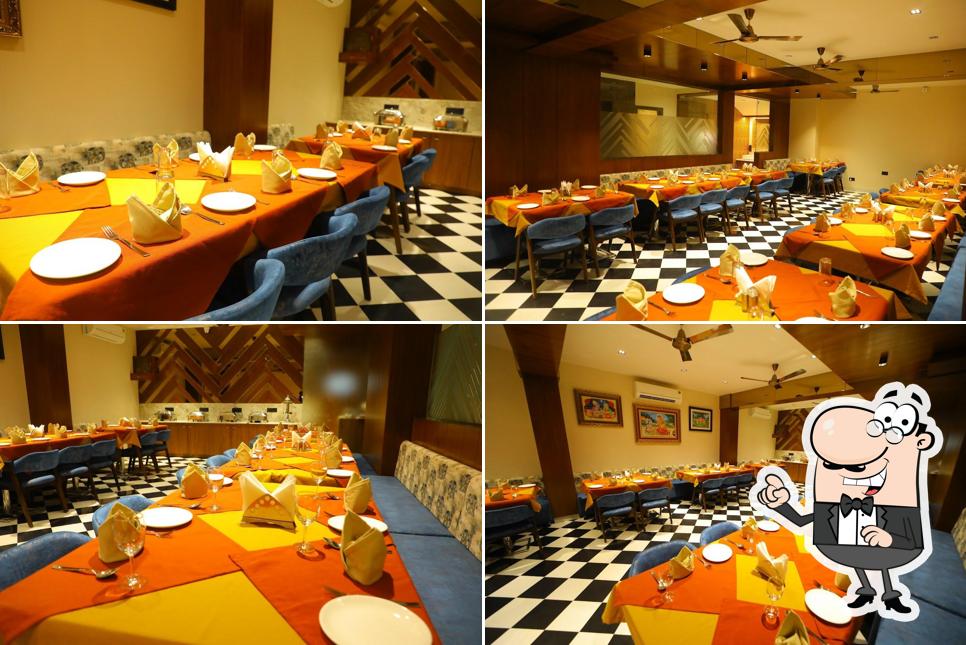 Take a seat at one of the tables at Prasadam Restaurant - Best Restaurant near Shrinathji Temple