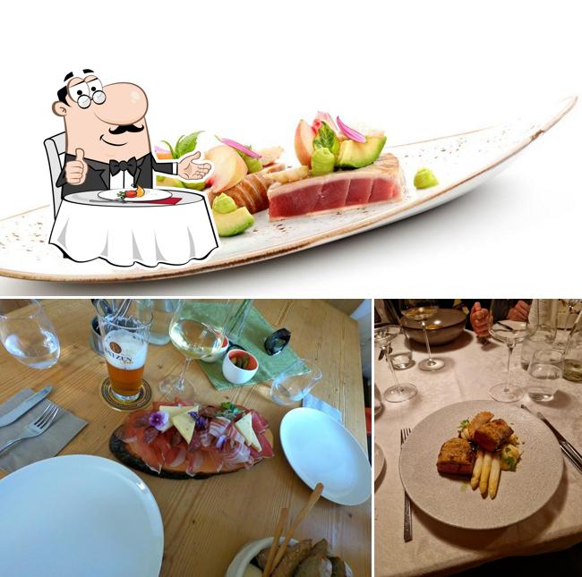 Guarda la immagine che mostra la tavolo da pranzo e cibo di Restaurant Sichelburg