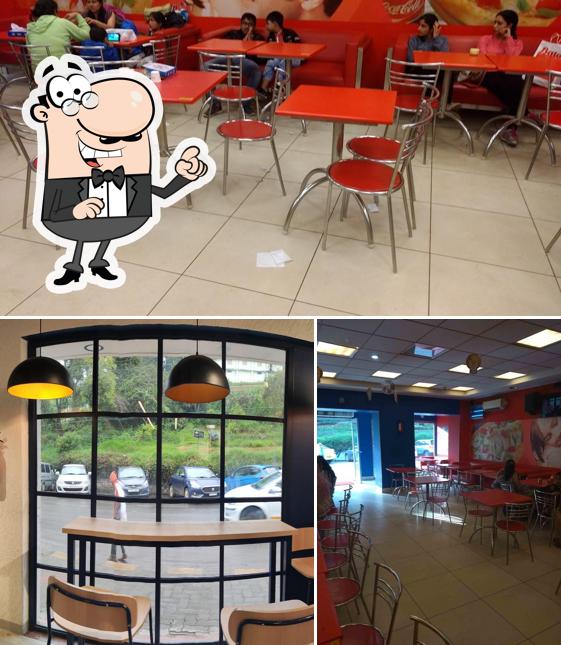 Take a seat at one of the tables at Domino's Pizza - Ooty