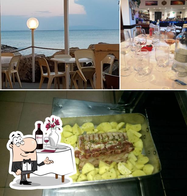 Dai un’occhiata alla foto che mostra la tavolo da pranzo e cibo di Ristorante Pizzeria Il Pescatore