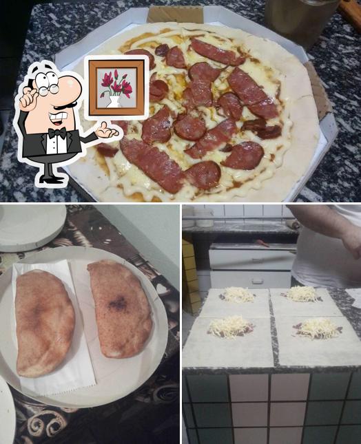 Mira las fotos que muestran interior y pizza en Pizzaria Caue