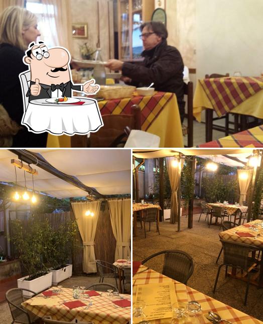 Guarda la foto che mostra la tavolo da pranzo e interni di Trattoria Da Milla