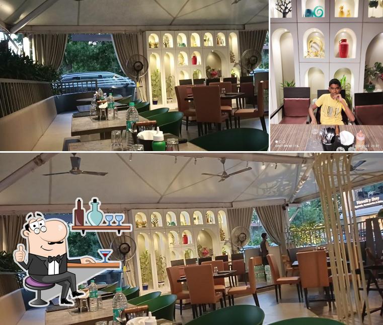 Take a seat at one of the tables at Veggies - Veg Fast Food Restaurant