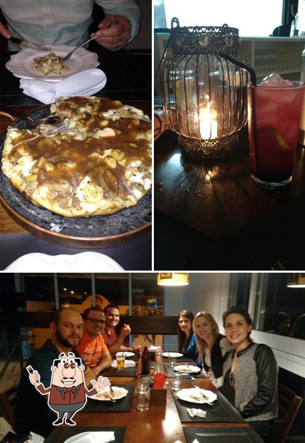 Confira a imagem mostrando comida e mesa de jantar no Zapatteria Pizza-Bar