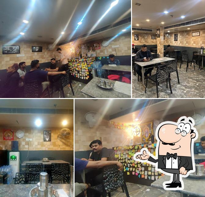 Take a seat at one of the tables at अन्ना का दुकान