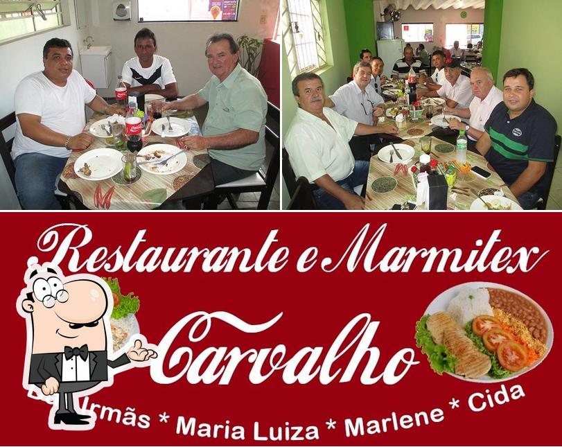 Take a look at the picture displaying interior and beverage at Restaurante Carvalho