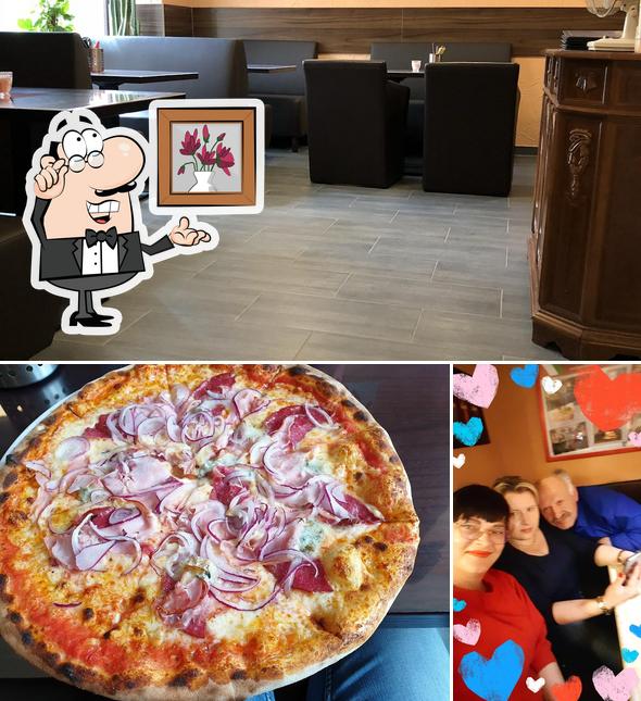 Фото, на котором видны внутреннее оформление и пицца в Pizza Dom Schongau