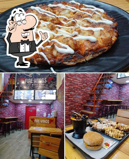 Take a look at the photo depicting interior and pizza at Fire Wings