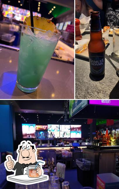 Among various things one can find drink and bar counter at Dave & Buster's Green Bay