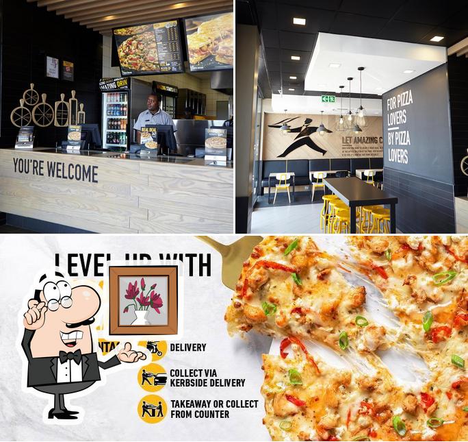 This is the photo depicting interior and pizza at Debonairs Pizza