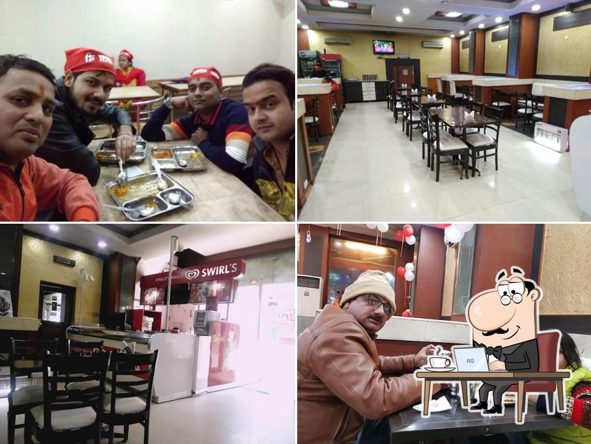 Take a seat at one of the tables at Premier Pure Veg Restaurant