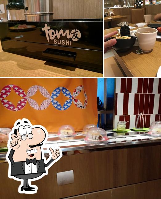 This is the photo showing interior and dining table at Tom Sushi