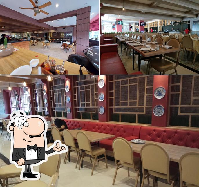 Take a seat at one of the tables at Wang Dynasty Restaurant - Apang Resto & Coffee Shop