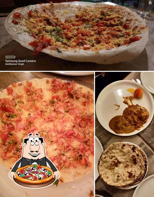 Get pizza at Delhi Kitchen