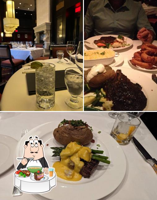 The picture of dining table and food at Hy's Steakhouse and Cocktail Bar