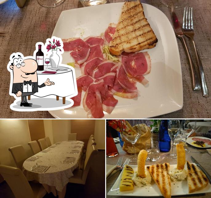 Guarda la immagine che mostra la tavolo da pranzo e cibo di Locanda Carollo