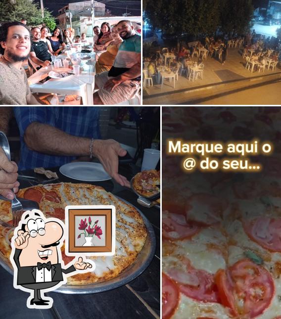 Dê uma olhada a foto ilustrando interior e comida a Klebyo Pizzaria