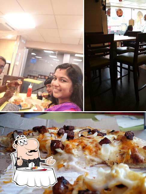 The image of dining table and pizza at Domino's Pizza