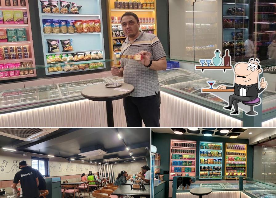 Take a seat at one of the tables at Sheetal Restaurant - Ice Cream, South Indian & Fast Food