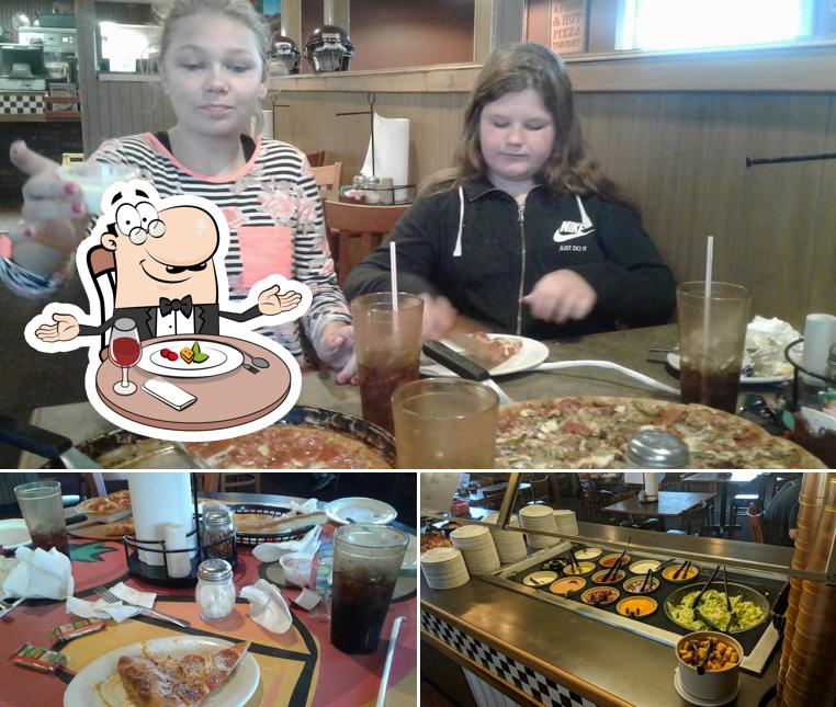 Check out the photo depicting dining table and food at Pizza Hut