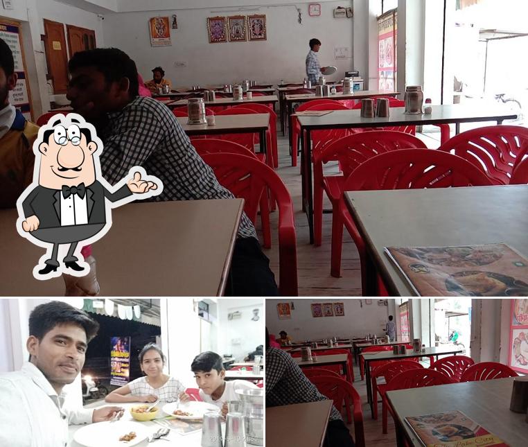 Take a seat at one of the tables at Bholenath Restaurant And Dining Hall