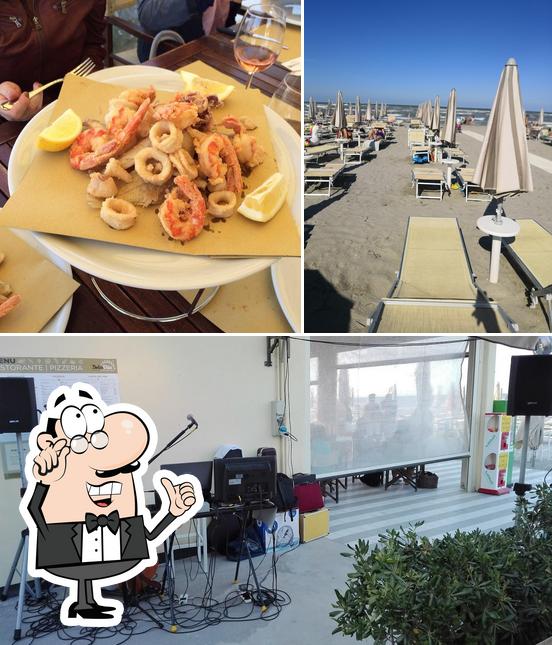 Tra le diverse cose da DolceVita Beach, Restaurant & Bar si possono trovare la interni e tavolo da pranzo