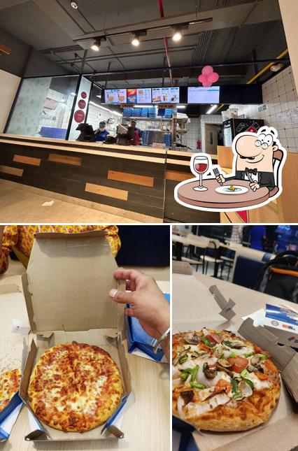 Check out the image displaying food and interior at Domino's Pizza - Model Town