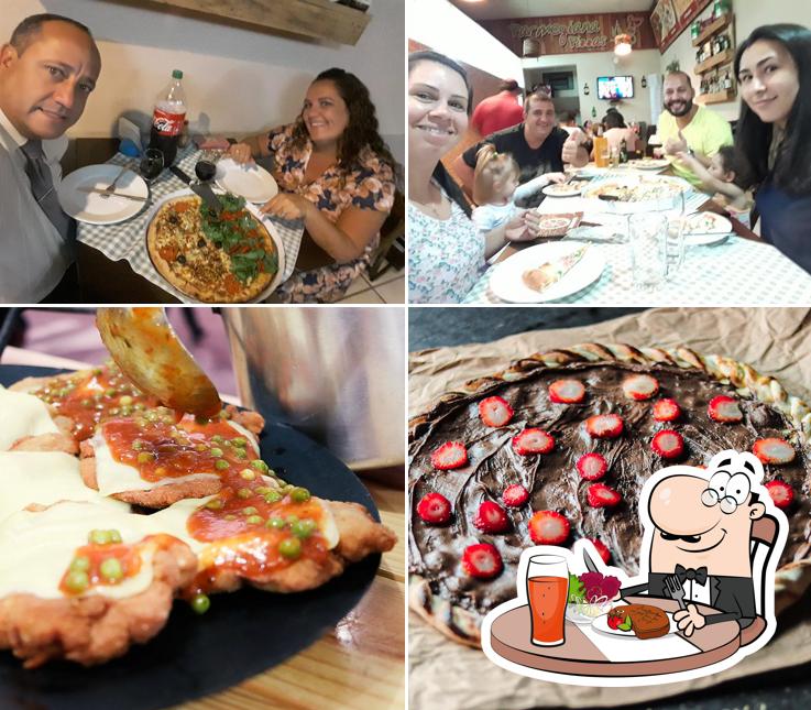 Confira a foto ilustrando mesa de jantar e comida no Parmegiana Pizzas