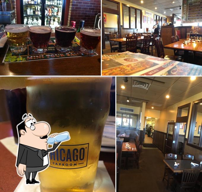 Take a look at the image showing drink and interior at Old Chicago Pizza + Taproom