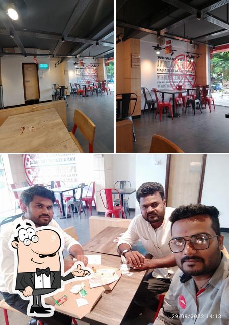 The photo of interior and dining table at Pizza Hut Javergi Road, Gulbarga