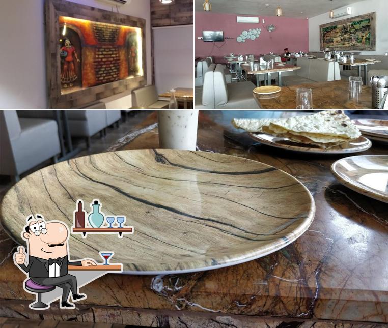 Take a seat at one of the tables at Shree Balaji Garden Restaurant