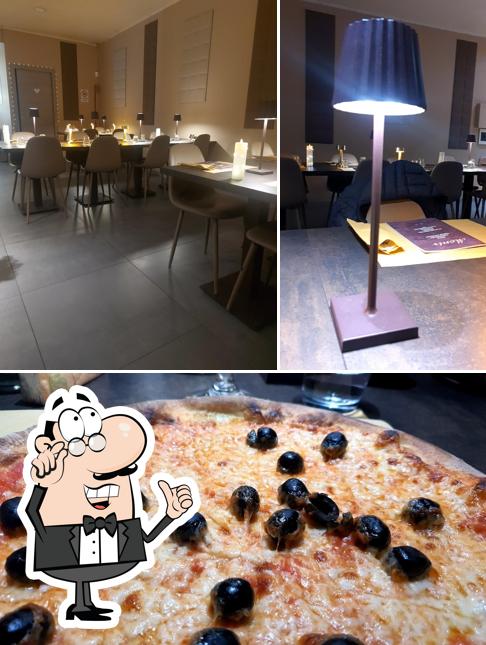 Questa è la foto che presenta la interni e cibo di Pizzeria da Monir