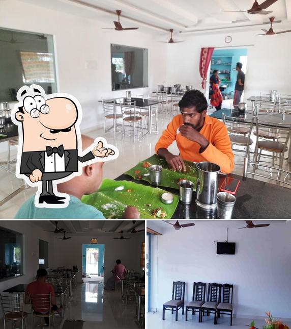 Take a seat at one of the tables at HOTEL SRI RAM