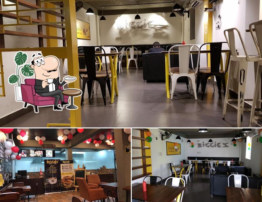 Take a seat at one of the tables at Biggies Burger : Hosur