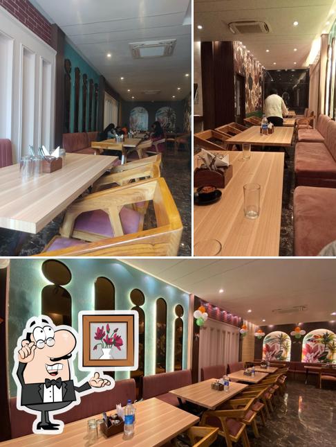 Take a seat at one of the tables at BINDAAS Funzone Restaurant & Lounge