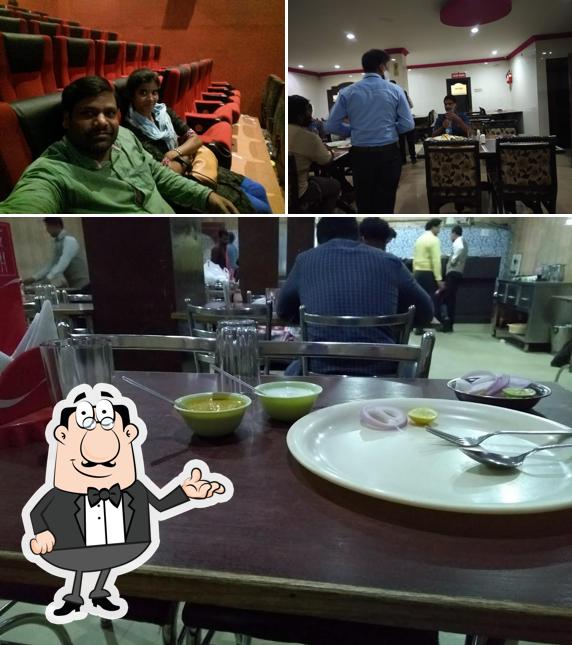 Take a seat at one of the tables at Hotel Biryani Mahal