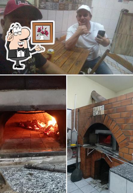 O interior do Pizzaria e Esfiharia Califórnia 27 anos