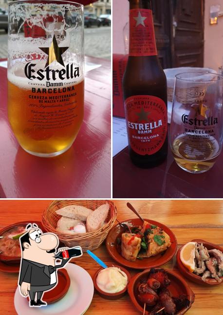 Take a look at the picture displaying drink and food at El Tinto Bodega - Tapas Bar