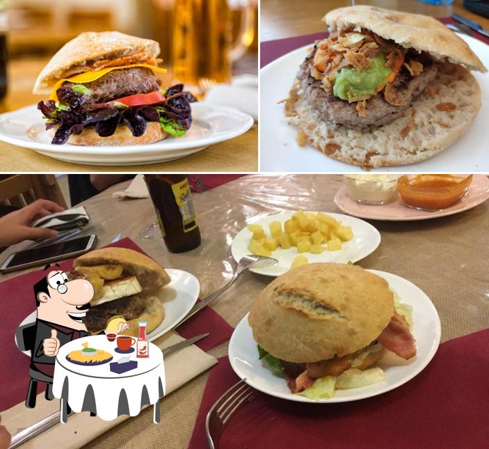 Try out a burger at Cafetería-Restaurante El Jardín Meeting Point