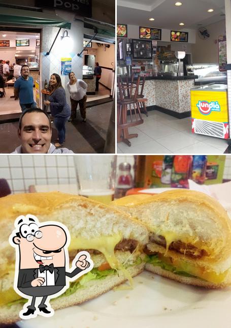 Dê uma olhada a imagem apresentando interior e sanduíche no Pop Lanches