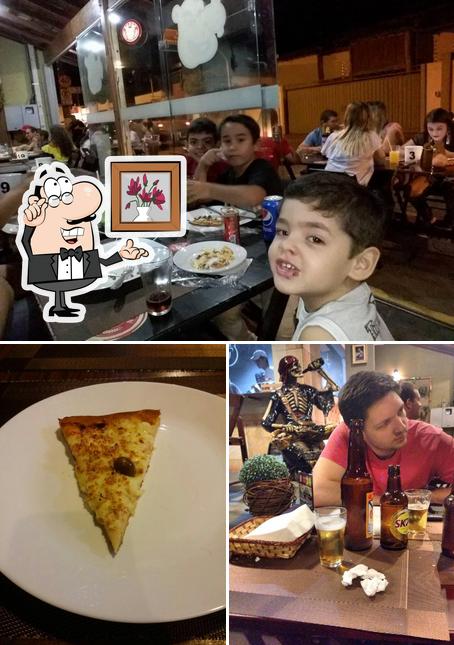 Confira a imagem apresentando interior e pizza a Hippo Pizza