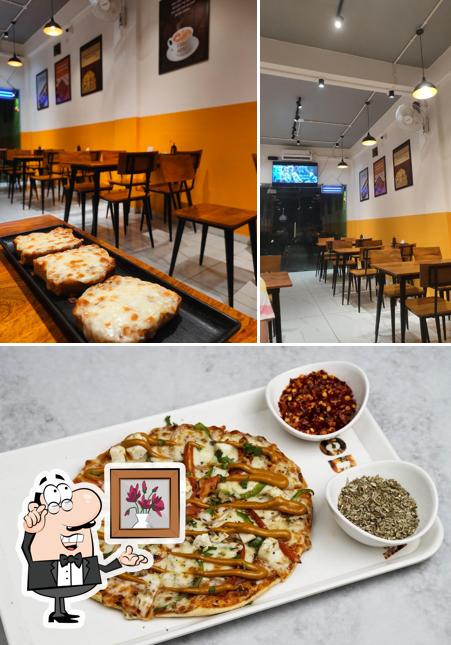 The photo of interior and food at Food Adda Mahuva