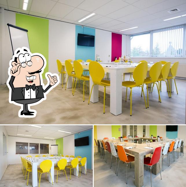 Take a seat at one of the tables at Urban OUTKA - Zaalverhuur, Vergaderen & Trainingslocatie Lage Weide