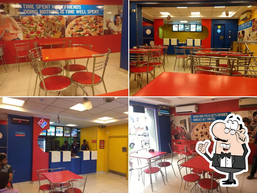 Take a seat at one of the tables at Domino's Pizza Vellayambalam, Thiruvananthapuram