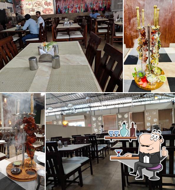 Take a seat at one of the tables at Hotel Mavala - Veg Non-Veg family restaurant
