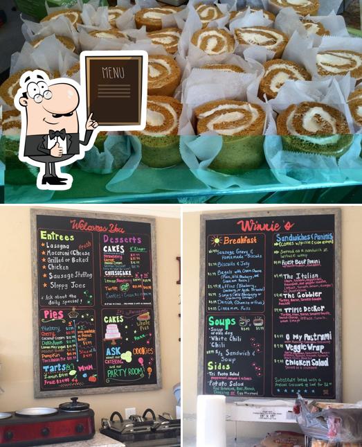 Take a look at the picture showing blackboard and food at Winnie's Decadent Desserts & Deli