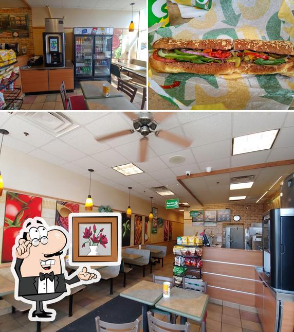 Check out the picture depicting interior and burger at Subway